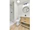 Renovated bathroom featuring a custom vanity, mirror, and walk-in shower at 11935 E Ford Dr, Aurora, CO 80012