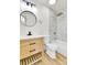 Bathroom featuring a modern vanity, round mirror, and bathtub shower at 11935 E Ford Dr, Aurora, CO 80012