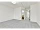 Spacious bedroom with a bathroom, closet, and light-colored gray carpet at 11935 E Ford Dr, Aurora, CO 80012