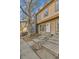Charming townhouse featuring a stone facade and well-maintained front yard with mature trees at 11935 E Ford Dr, Aurora, CO 80012