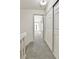 Hallway showing the closet and view into the bedroom with gray carpet at 11935 E Ford Dr, Aurora, CO 80012