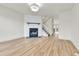 Bright living room with fireplace, wood floors, and stairs leading to the second floor at 11935 E Ford Dr, Aurora, CO 80012