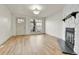 Inviting living room featuring wood floors, a brick fireplace, and a bright window at 11935 E Ford Dr, Aurora, CO 80012