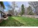Large backyard with green grass, mature trees, a gazebo, and garden shed at 8029 W Hoover Pl, Littleton, CO 80123