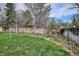 Green backyard featuring a healthy lawn, a blooming flowerbed, and a wooden fence at 8029 W Hoover Pl, Littleton, CO 80123
