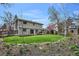 Expansive backyard featuring lush green lawn, garden area, mature trees, gazebo, and rear view of the home at 8029 W Hoover Pl, Littleton, CO 80123