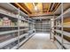 Unfinished basement offering ample storage with open shelving and exposed beams at 8029 W Hoover Pl, Littleton, CO 80123
