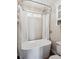 The soaking tub in this modern bathroom has a shower, window, and built-in shelves at 8029 W Hoover Pl, Littleton, CO 80123