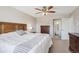 This primary bedroom features a ceiling fan, ensuite bathroom, and plenty of natural light at 8029 W Hoover Pl, Littleton, CO 80123