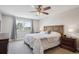 This cozy bedroom features a ceiling fan, a large window, and room for your furniture at 8029 W Hoover Pl, Littleton, CO 80123