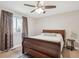 Cozy bedroom with natural light, ceiling fan, and space for a relaxing night's sleep at 8029 W Hoover Pl, Littleton, CO 80123