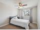 Relaxing bedroom with ceiling fan, natural light, and comfortable carpet at 8029 W Hoover Pl, Littleton, CO 80123