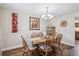 Inviting dining room with a rustic wooden table, elegant chandelier, and wine rack for entertaining at 8029 W Hoover Pl, Littleton, CO 80123