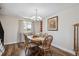 Cozy dining room with a wooden table, cushioned chairs, and a bright window offering natural light at 8029 W Hoover Pl, Littleton, CO 80123
