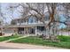 Charming two-story home with manicured lawn and inviting front porch, perfect for enjoying the outdoors at 8029 W Hoover Pl, Littleton, CO 80123