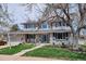 Beautiful two-story home featuring a well-kept lawn, flowerbeds, and an inviting front porch area at 8029 W Hoover Pl, Littleton, CO 80123