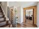Inviting foyer with hardwood floors, modern staircase, and wood framed office entrance at 8029 W Hoover Pl, Littleton, CO 80123