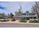 Charming home with front lawn, mature trees, and driveway at 8029 W Hoover Pl, Littleton, CO 80123