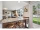 View of kitchen and breakfast bar with access to backyard at 8029 W Hoover Pl, Littleton, CO 80123