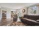 Living room with hardwood floors and a view into the kitchen at 8029 W Hoover Pl, Littleton, CO 80123