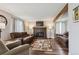 Living room features a fireplace, hardwood floors, and lots of natural light at 8029 W Hoover Pl, Littleton, CO 80123