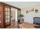 Charming home office with sliding barn doors, wooden desk, and decor at 8029 W Hoover Pl, Littleton, CO 80123