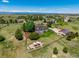 Expansive property featuring an outdoor dining area, large pergola, and well-manicured lawn with mature trees at 8184 S Ireland Way, Aurora, CO 80016