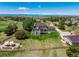 Beautiful aerial shot of a grand estate with a large lawn, pergola-covered deck, and outdoor dining area at 8184 S Ireland Way, Aurora, CO 80016