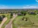 Stunning aerial view of a luxury home with lush landscaping, a long private driveway, and expansive grounds at 8184 S Ireland Way, Aurora, CO 80016