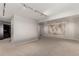 Finished basement with neutral carpet and paint, featuring a map accent wall, recessed lighting, and a storage area at 8184 S Ireland Way, Aurora, CO 80016