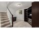 Basement landing with carpeted stairs, dark built-in shelves, and a small desk at 8184 S Ireland Way, Aurora, CO 80016