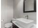Modern powder room featuring a vessel sink, and sleek faucet at 8184 S Ireland Way, Aurora, CO 80016