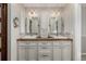 Elegant bathroom featuring a dual sink vanity with warm wood counters at 8184 S Ireland Way, Aurora, CO 80016
