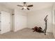 Bedroom with carpet, a ceiling fan, a double door closet, and an exercise machine at 8184 S Ireland Way, Aurora, CO 80016