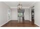 Bright dining room featuring hardwood floors and a stylish wooden chandelier at 8184 S Ireland Way, Aurora, CO 80016