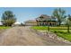 Charming home featuring a large yard, gravel driveway, and a three-car garage, with a separate garage in the back at 8184 S Ireland Way, Aurora, CO 80016