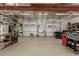 Large garage with overhead beams, multiple bays, and workbenches along the back wall at 8184 S Ireland Way, Aurora, CO 80016