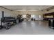 Oversized garage with smoker, large grills, refrigerator, shelving, and work tables at 8184 S Ireland Way, Aurora, CO 80016