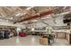 Spacious garage featuring a workbench area, ample shelving, and storage solutions for various tools and equipment at 8184 S Ireland Way, Aurora, CO 80016