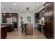 Kitchen featuring dark wood cabinets, granite countertops, stainless steel appliances, and hardwood floors at 8184 S Ireland Way, Aurora, CO 80016