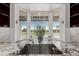 A kitchen sink features granite countertops and a window view of the outdoor patio at 8184 S Ireland Way, Aurora, CO 80016