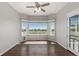 Living room features hardwood floors, a bay window with a view, and a door to the patio at 8184 S Ireland Way, Aurora, CO 80016