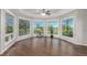 Bright living room boasting hardwood floors, large windows with backyard views, and modern ceiling fan at 8184 S Ireland Way, Aurora, CO 80016
