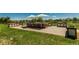 Spacious outdoor patio with dining table, chairs, and shade umbrellas, surrounded by planters and lush lawn at 8184 S Ireland Way, Aurora, CO 80016
