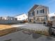 View of backyard that shows the home's gray exterior and the backyard's lawn at 21901 E 42Nd Place, Aurora, CO 80019