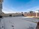 Spacious backyard with a wood fence and a wintery covering of snow at 21901 E 42Nd Place, Aurora, CO 80019