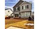 Landscaped backyard featuring a concrete patio, stone accents, and brown grass at 21901 E 42Nd Place, Aurora, CO 80019