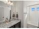 This bathroom features a vanity with granite countertops and a shower-tub combo at 21901 E 42Nd Place, Aurora, CO 80019