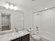 Bathroom with a granite countertop vanity, mirror, and a tiled shower-tub combo at 21901 E 42Nd Place, Aurora, CO 80019