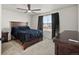 Comfortable bedroom featuring a large bed, dark wood furniture, and natural light at 21901 E 42Nd Place, Aurora, CO 80019